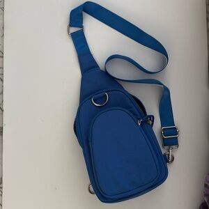 Blue nylon sling bag. Cross body.